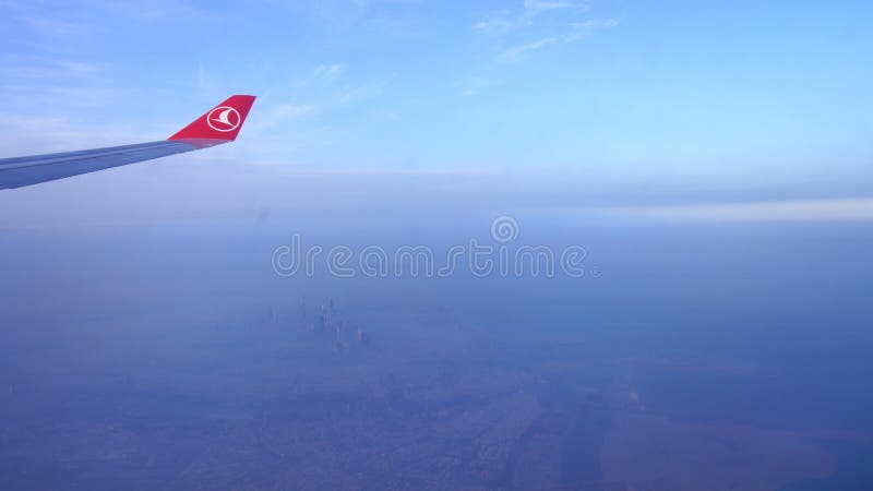 Il DUBAI, EMIRATI ARABI UNITI - 30 marzo 2014: Una vista della finestra e dell'ala da un aeroplano di Turkish Airlines con la mat immagini stock libere da diritti Il DUBAI, EMIRATI ARABI UNITI - 30 marzo 2014: Una vista della finestra e dell'ala da un aeroplano di Turkish Airlines con la mat immagini stock libere da diritti