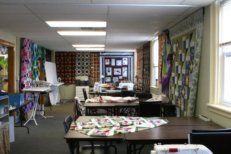 Interior of quilting workroom, including quilting and sewing machine rooms and sample quilts. Interior of quilting workroom, including quilting and sewing machine rooms and sample quilts