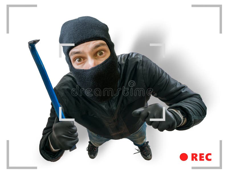 Masked robber or burglar is recorded with security hidden camera. Masked robber or burglar is recorded with security hidden camera.