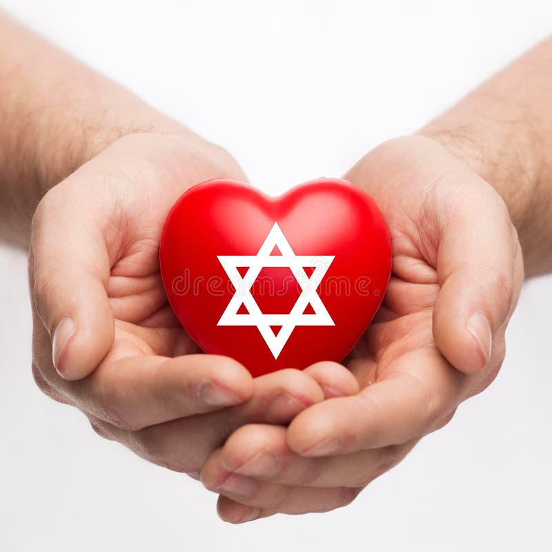 Religion, christianity and charity concept - male hands holding red heart with star of david symbol. Religion, christianity and charity concept - male hands holding red heart with star of david symbol