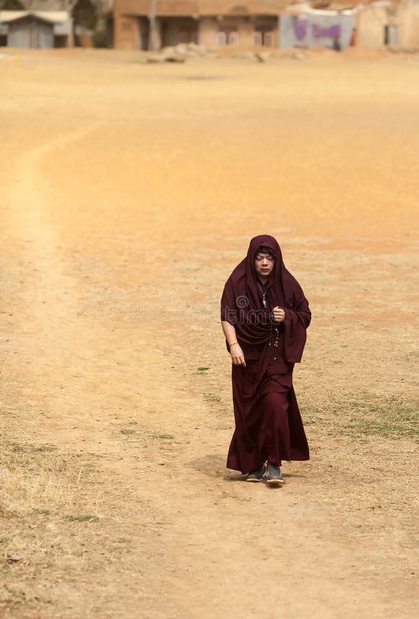 Il monaco va sull'area del deserto che conta le perle in mani fotografia stock Il monaco va sull'area del deserto che conta le perle in mani fotografia stock