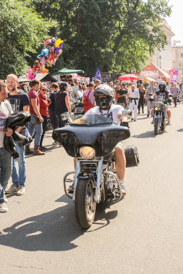 Il motociclista sta guidando un motociclo dopo la gente immagini stock Il motociclista sta guidando un motociclo dopo la gente immagini stock