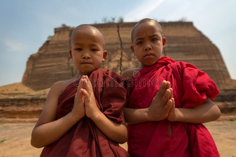 Il Myanmar due piccoli monaci paga la fede di rispetto di buddismo in Myan immagine stock Il Myanmar due piccoli monaci paga la fede di rispetto di buddismo in Myan immagine stock