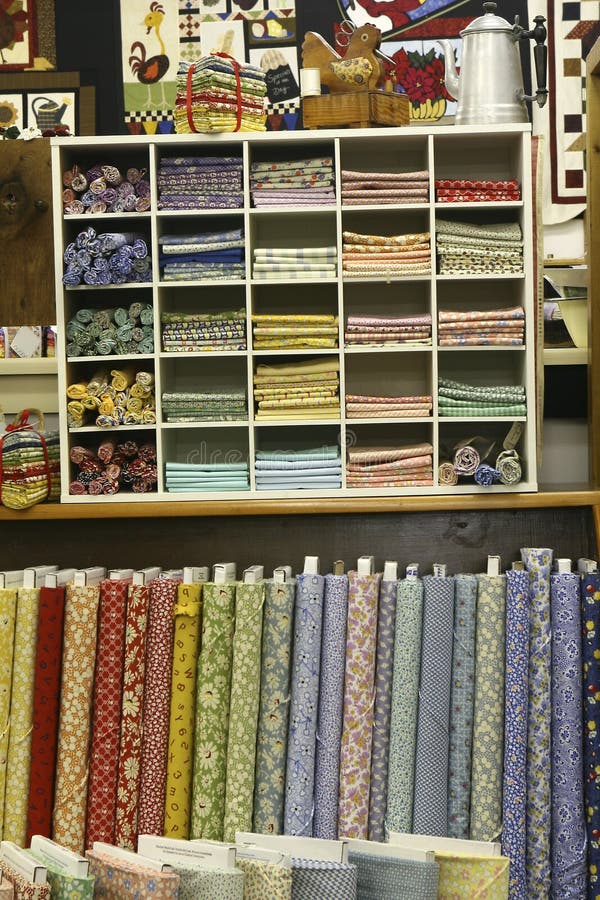 Interior of a quilt shop with stacks of fat quarters and fabric bolts on display. Interior of a quilt shop with stacks of fat quarters and fabric bolts on display