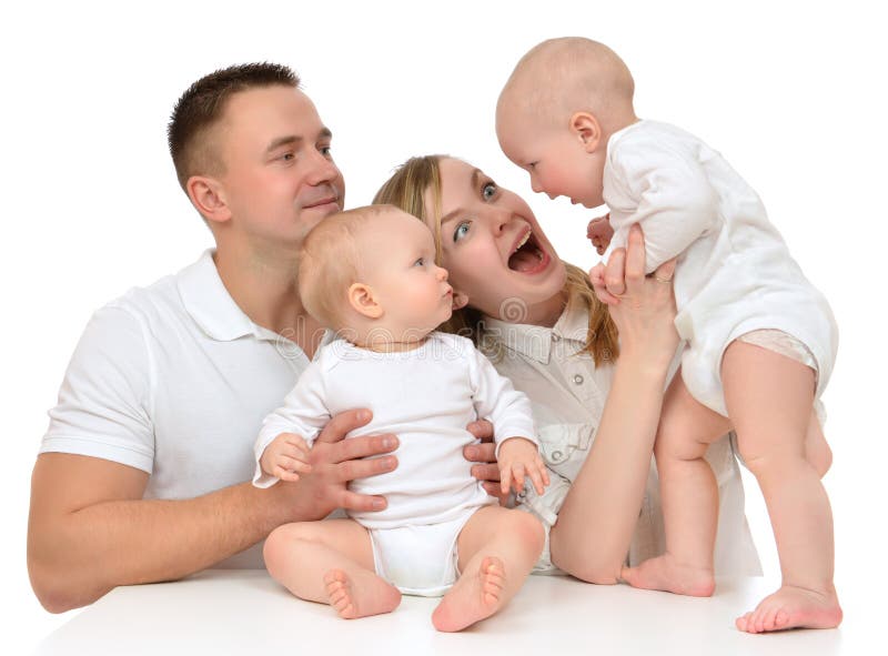 Young happy family mother and father with newborn child baby kids playing yelling isolated on a white background. Young happy family mother and father with newborn child baby kids playing yelling isolated on a white background