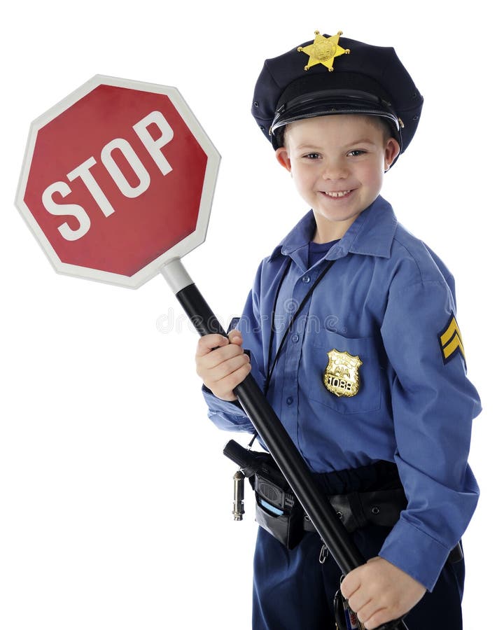 An adorable young policeman happily holding a stop sign. On a white background. An adorable young policeman happily holding a stop sign. On a white background.