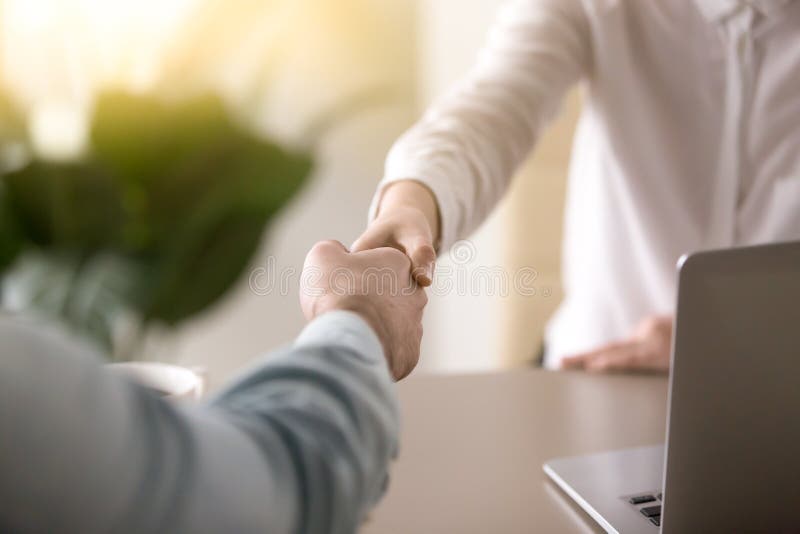 Close up of a handshake, male and female hands shaking as a symbol of effective negotiations, making agreement, greeting business partner or mutual respect and gender equality in relationships. Close up of a handshake, male and female hands shaking as a symbol of effective negotiations, making agreement, greeting business partner or mutual respect and gender equality in relationships