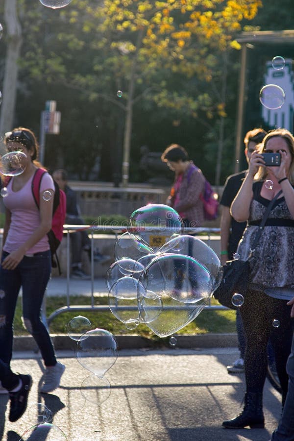 Barcelona, Spain - October 9, 2017: Public walks on Boulevard among soap bubbles different shape and size. Urban entertainment. Barcelona, Spain - October 9, 2017: Public walks on Boulevard among soap bubbles different shape and size. Urban entertainment
