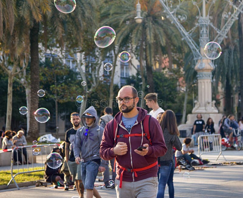 Barcelona, Spain - October 9, 2017: Public walks on Boulevard among soap bubbles different shape and size. Urban entertainment. Barcelona, Spain - October 9, 2017: Public walks on Boulevard among soap bubbles different shape and size. Urban entertainment