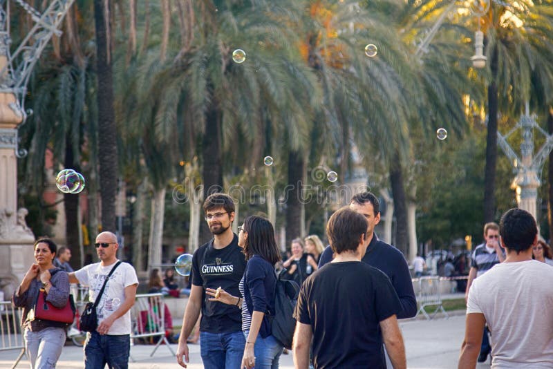 Barcelona, Spain - October 9, 2017: Public walks on Boulevard among soap bubbles different shape and size. Urban entertainment. Barcelona, Spain - October 9, 2017: Public walks on Boulevard among soap bubbles different shape and size. Urban entertainment