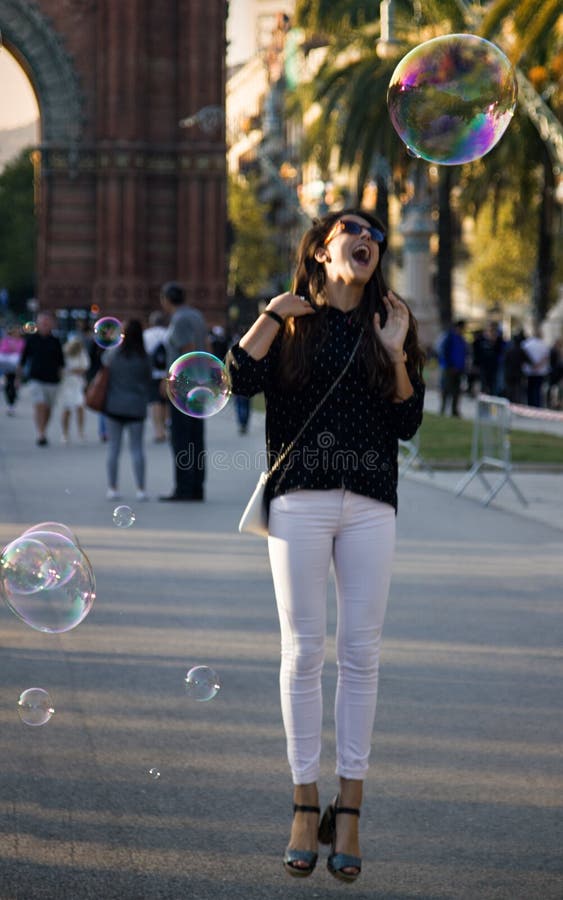 Barcelona, Spain - October 9, 2017: Public walks on Boulevard among soap bubbles different shape and size. Urban entertainment. Takeoff in balloon, cool photo. Barcelona, Spain - October 9, 2017: Public walks on Boulevard among soap bubbles different shape and size. Urban entertainment. Takeoff in balloon, cool photo