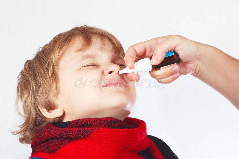 Little boy used a medical nasal spray in the nose on a white background. Little boy used a medical nasal spray in the nose on a white background