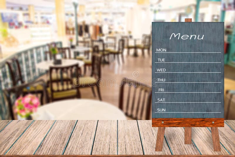 Wooden menu display sign, Frame restaurant message board on wooden table, Blurred image background, Template mock up for adding your design and leave space beside frame for adding more text. Wooden menu display sign, Frame restaurant message board on wooden table, Blurred image background, Template mock up for adding your design and leave space beside frame for adding more text.