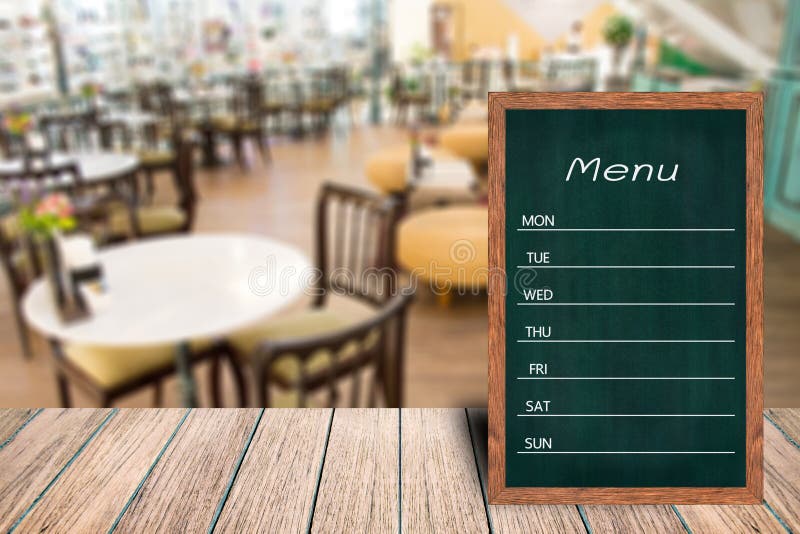 Wooden menu display sign, Frame restaurant message board on wooden table, Blurred image background, Template mock up for adding your design and leave space beside frame for adding more text. Wooden menu display sign, Frame restaurant message board on wooden table, Blurred image background, Template mock up for adding your design and leave space beside frame for adding more text.