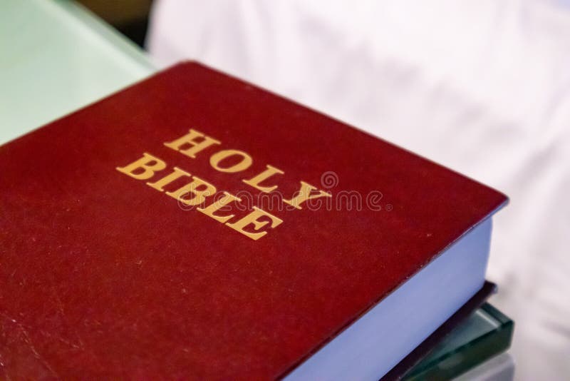 Holy Bible gold text on a leather cover book red color, close up view. Holy Bible gold text on a leather cover book red color, close up view