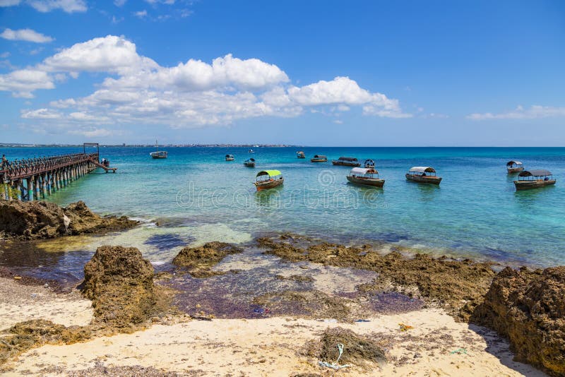 Seascape, ocean coast: view from Changuu Island Prison Island to azure water, tourist boats on the ocean surface. Zanzibar. Tanzania, Africa. Tourist destination, tourism attraction, beach holiday. Seascape, ocean coast: view from Changuu Island Prison Island to azure water, tourist boats on the ocean surface. Zanzibar. Tanzania, Africa. Tourist destination, tourism attraction, beach holiday