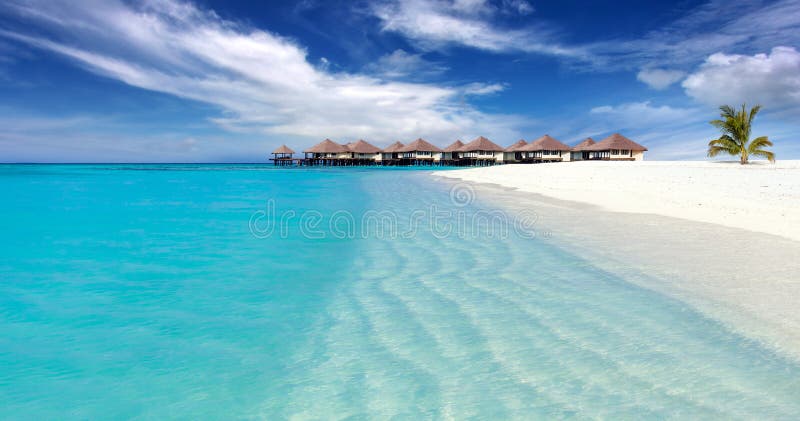 Tropical island with sandy beach, turquoise clear water and overwater bungalow, Maldives. Tropical island with sandy beach, turquoise clear water and overwater bungalow, Maldives