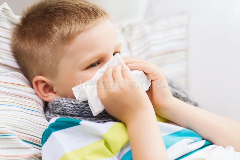 Ill boy with flu at home. Childhood, healthcare and medicine concept - ill boy with flu blowing nose at home stock photos Ill boy with flu at home. Childhood, healthcare and medicine concept - ill boy with flu blowing nose at home stock photos