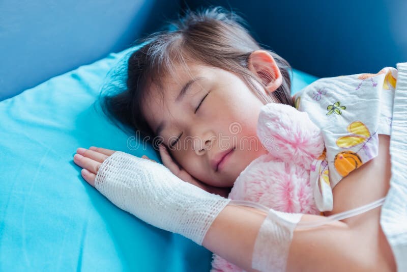 Illness asian child admitted in hospital with saline intravenous on hand stock photography Illness asian child admitted in hospital with saline intravenous on hand stock photography