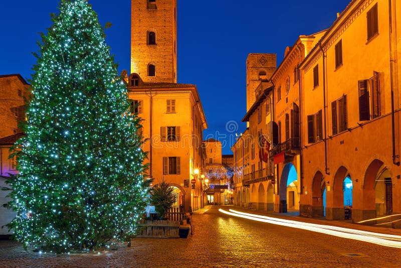 Illuminated Christmas tree on town square in Alba, Italy.