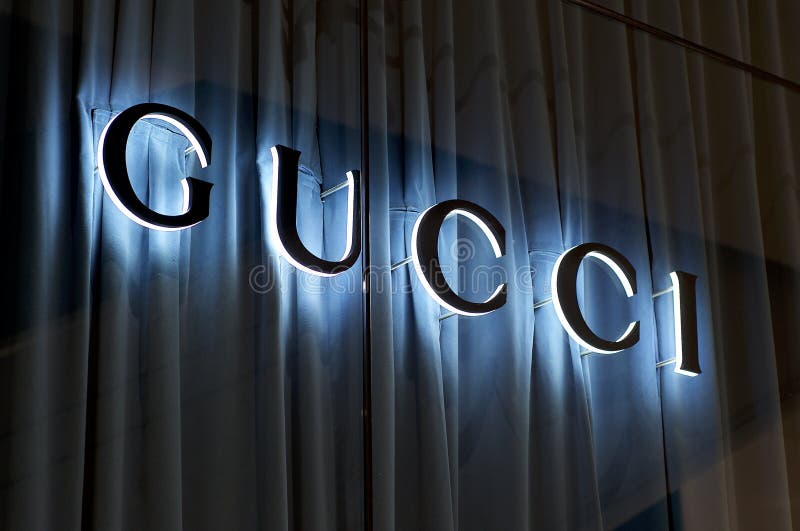 Illuminated Gucci Sign with Blue Curtain Background Editorial ...