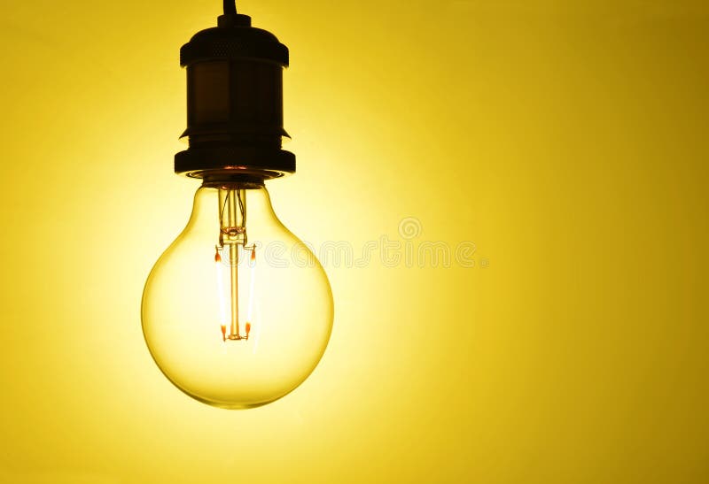 Illuminated hanging light bulb royalty free stock images