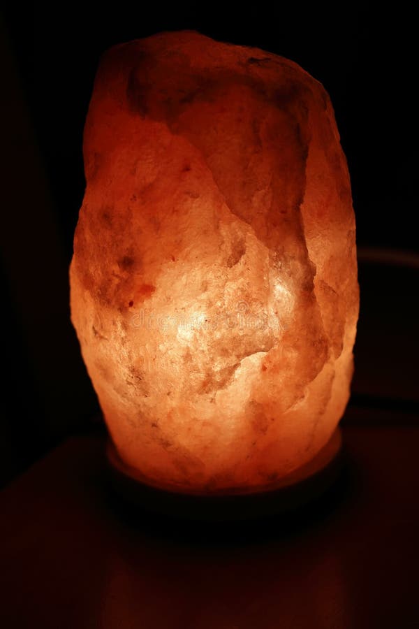 Illuminated Orange Himalayan Salt Lamp Light on a Dark Eve Stock Image ...