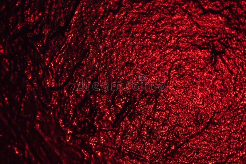 Illuminated in red black texture wall as a background stock photos