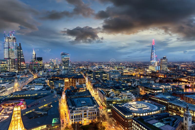 The illuminated skyline of London on evening time: from the City to the Tower Bridge, UK