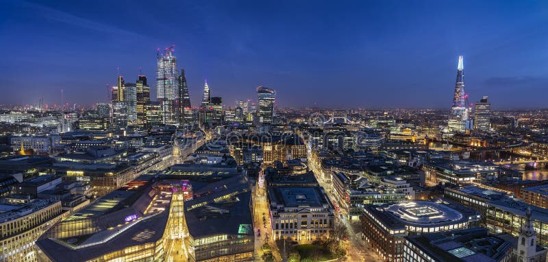 The illuminated skyline of London by night: from the City to the Tower bridge