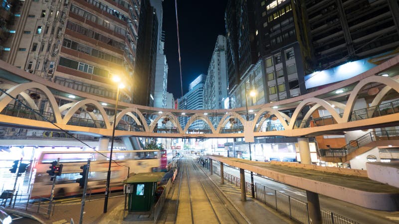Illuminated street of Hong Kong with rails and pedestrian bridge royalty free stock photography Illuminated street of Hong Kong with rails and pedestrian bridge royalty free stock photography