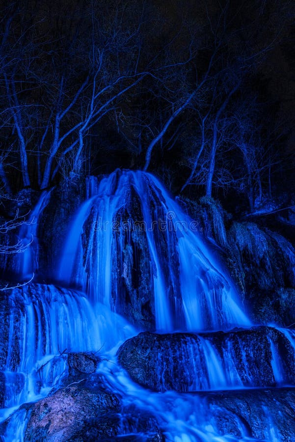 Illuminated waterfall Lucky with blue light at night. Slovakia