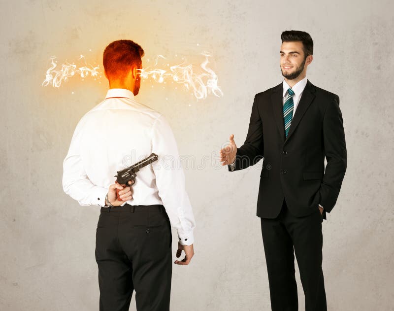 Angry businessman hiding a weapon behind his back. Angry businessman hiding a weapon behind his back