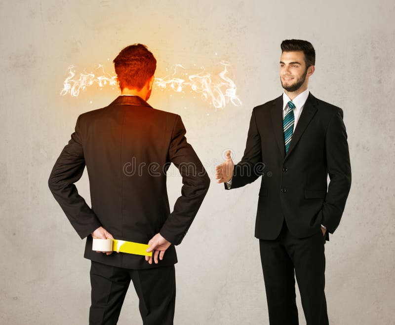 Angry businessman hiding a weapon behind his back. Angry businessman hiding a weapon behind his back