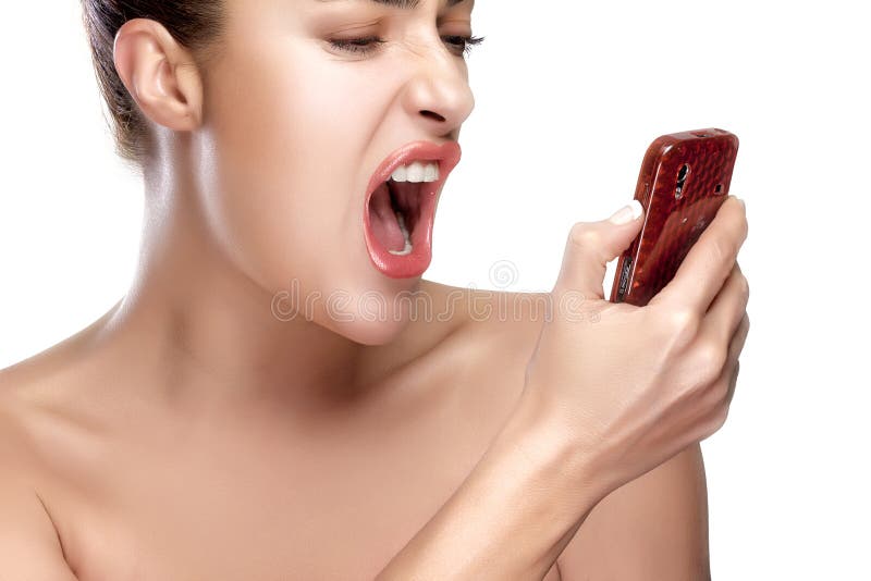 Angry young woman screaming on the mobile phone. Closeup portrait isolated on white. Angry young woman screaming on the mobile phone. Closeup portrait isolated on white