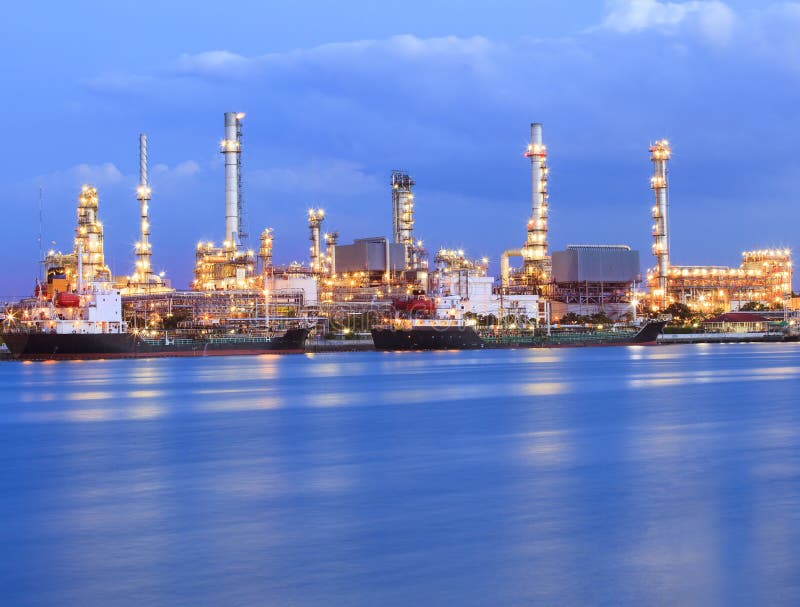 Iluminación hermosa de la planta de la industria de la refinería de petróleo al lado del uso azul del río para el tema del negoci foto de archivo libre de regalías Iluminación hermosa de la planta de la industria de la refinería de petróleo al lado del uso azul del río para el tema del negoci foto de archivo libre de regalías