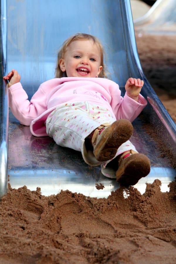 Little baby sliding in the playground. Little baby sliding in the playground