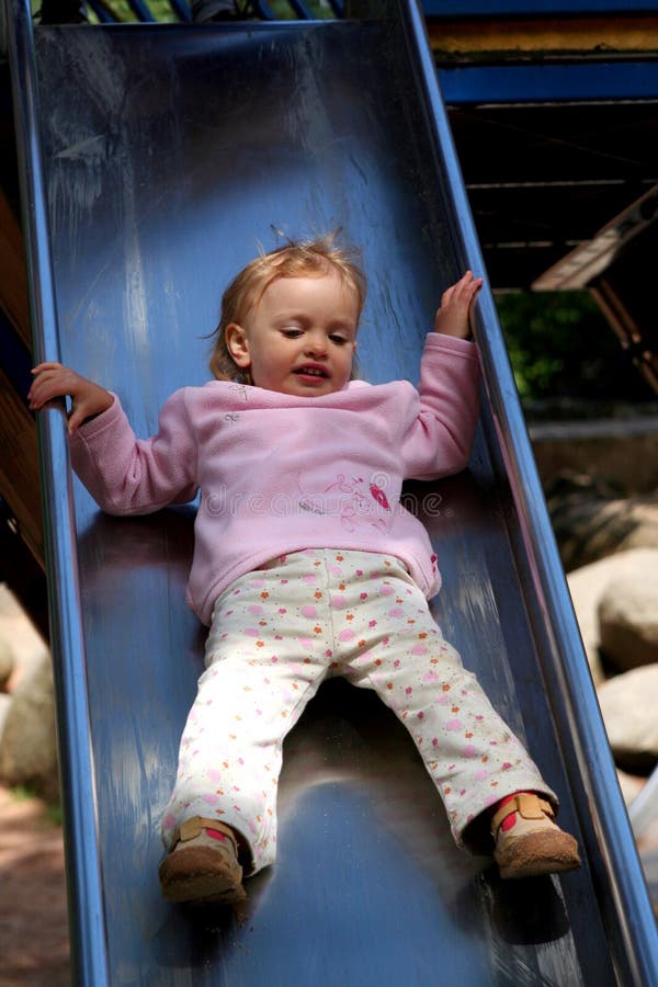 Little baby sliding in the playground. Little baby sliding in the playground