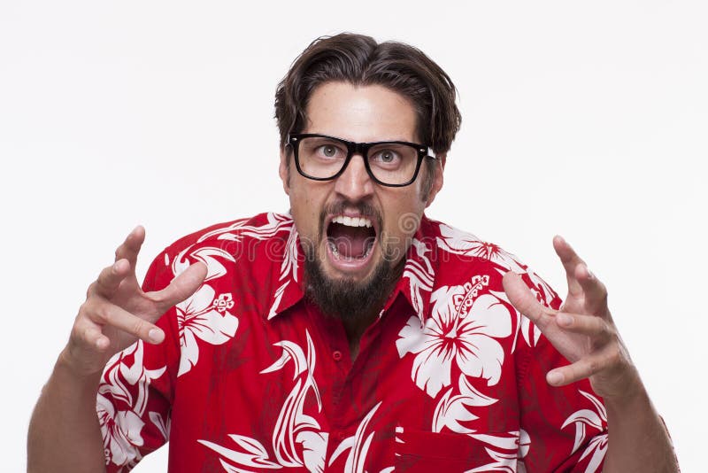 Image of a angry young man in Hawaiian shirt posing against whit