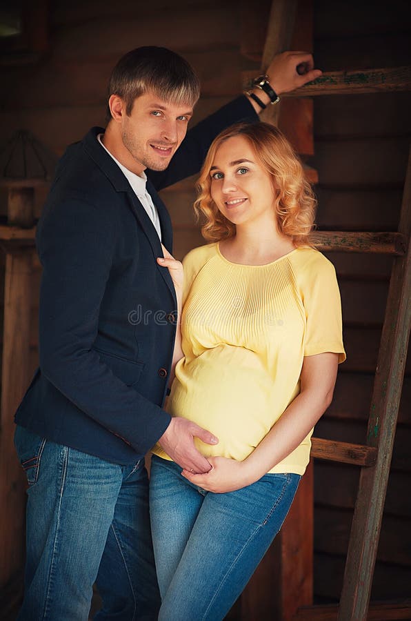 Image Of Beautiful Pregnant Woman And Her Handsome Husband Hugging The 
