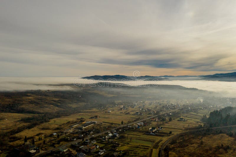 Image of beautiful village in the mountains, view of fog over little town, many houses in Lebanese mountain, gorgeous landscape, picturesque rural place, traveling and vacation concept.