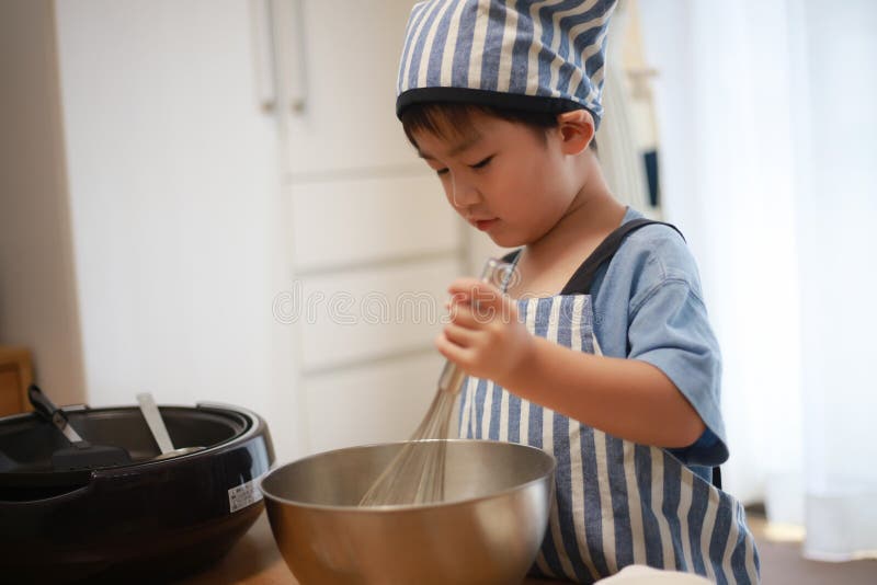 Boy making pancakes stock image. Image of cookware, food 248724753