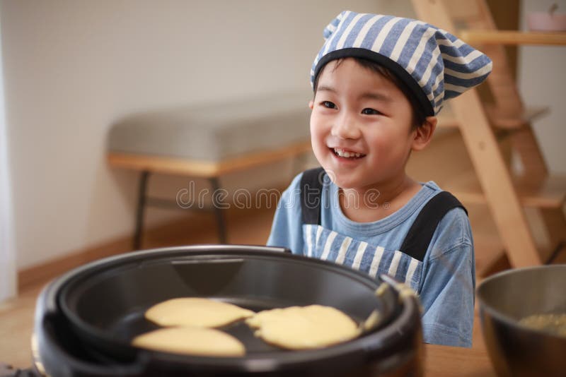 Boy making pancakes stock image. Image of childcare 248724627
