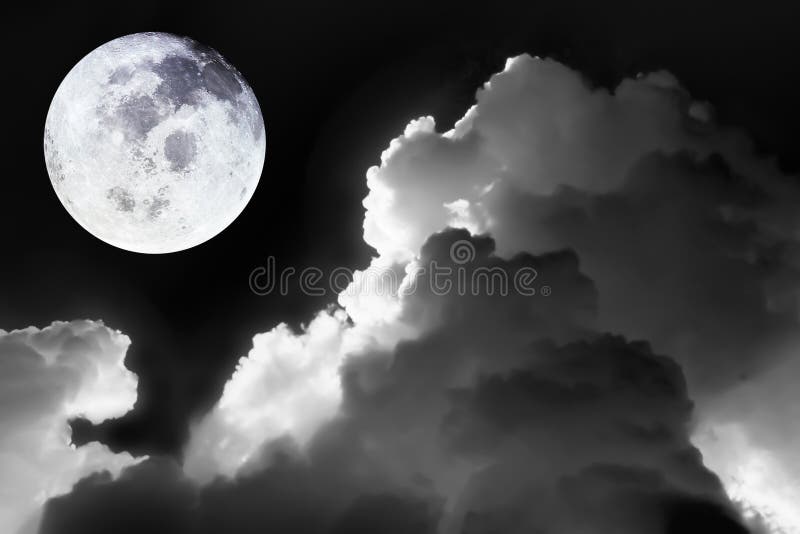 Image of bright full moon in dark sky with dramatic of light and texture on soft cloudscape in black and white for meteorology stock photography