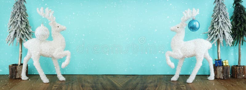 Image of Christmas Tree with Decorations and White Deer in Front of