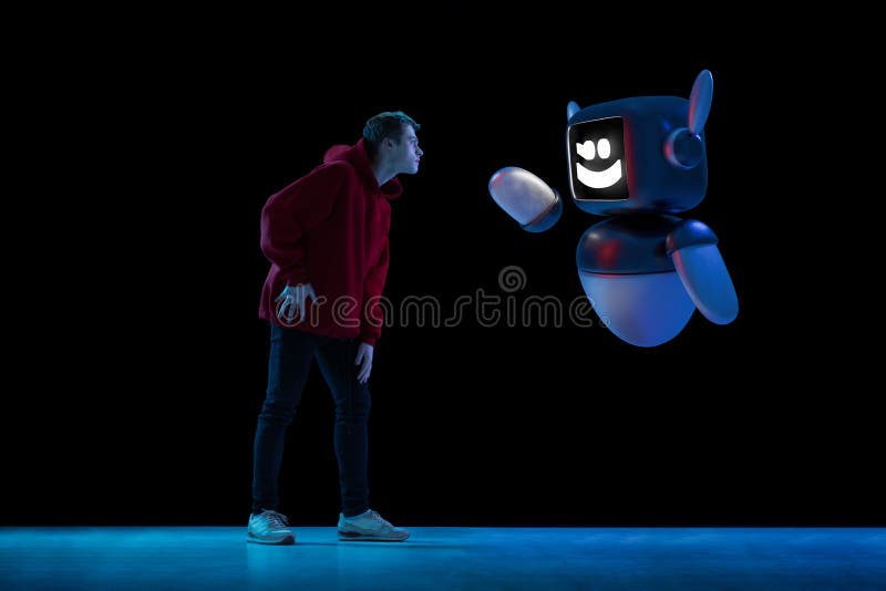 Image composite du jeune homme interagissant avec le modèle 3D du robot démontrant une coopération habile entre l'humain et photo libre de droits