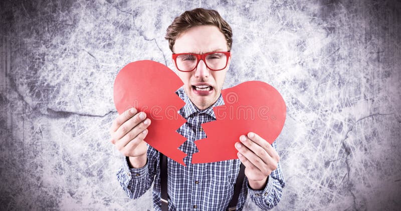 Image composée de hippie geeky tenant un coeur brisé photos libres de droits