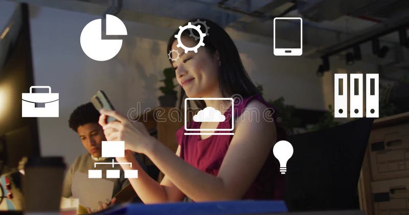 Image of computer application icons over asian businesswoman using smart phone in office stock photo