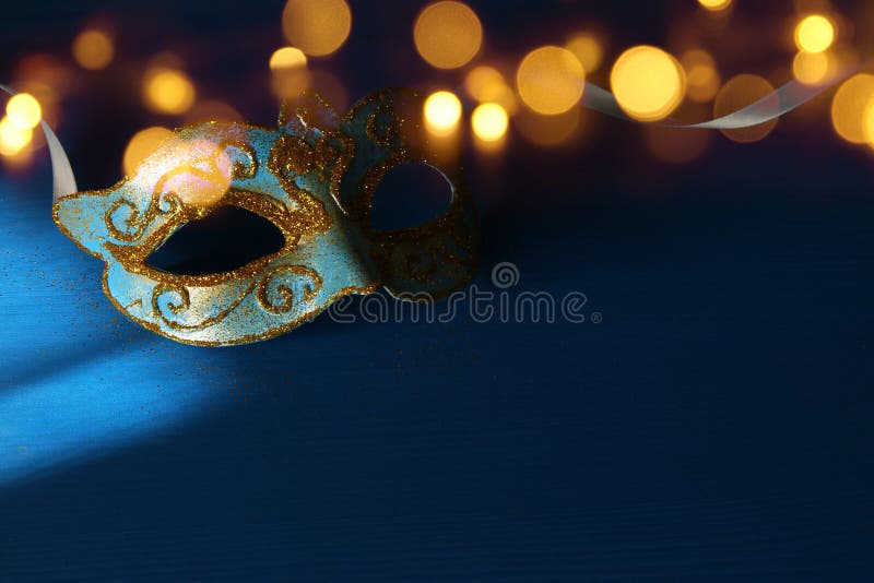 Image of elegant blue and gold venetian, mardi gras mask over blue background. royalty free stock photos