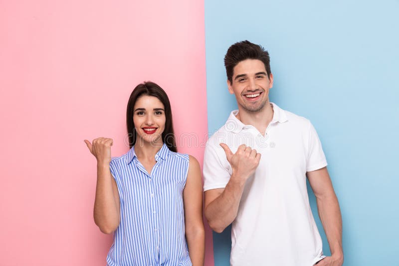 https://thumbs.dreamstime.com/b/image-european-couple-casual-wear-smiling-gesturing-fi-fingers-aside-isolated-over-colorful-background-132152588.jpg